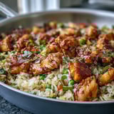 Fork-ready serving of One-Pan Bold Honey BBQ Chicken Rice featuring smoky BBQ aroma and colorful bell peppers in skillet.