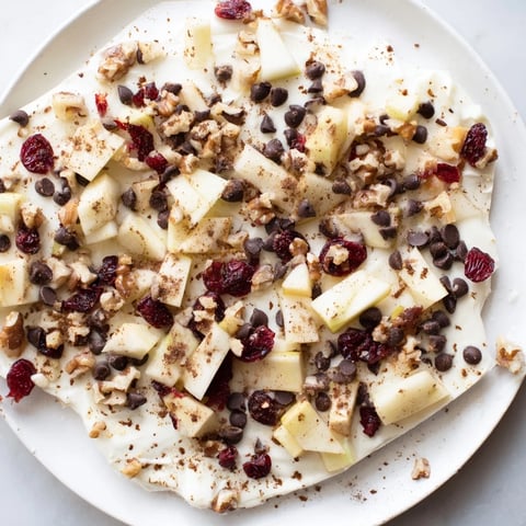 Frozen Apple Cinnamon Yogurt Bark, swirled with apples and nuts, ready for a refreshing treat.