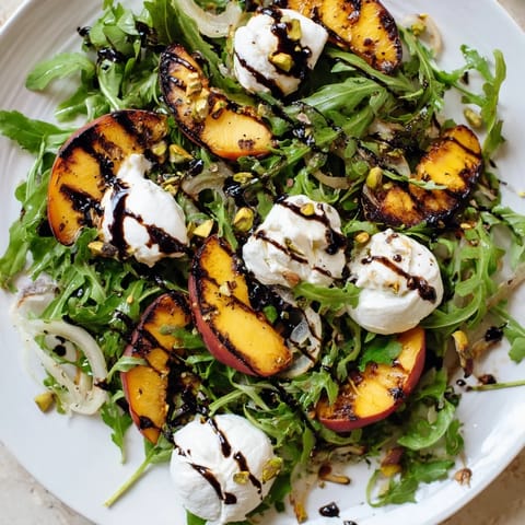 Fresh Grilled Peach Salad boasts vibrant colors and contrasting textures, perfect for a summer dinner.