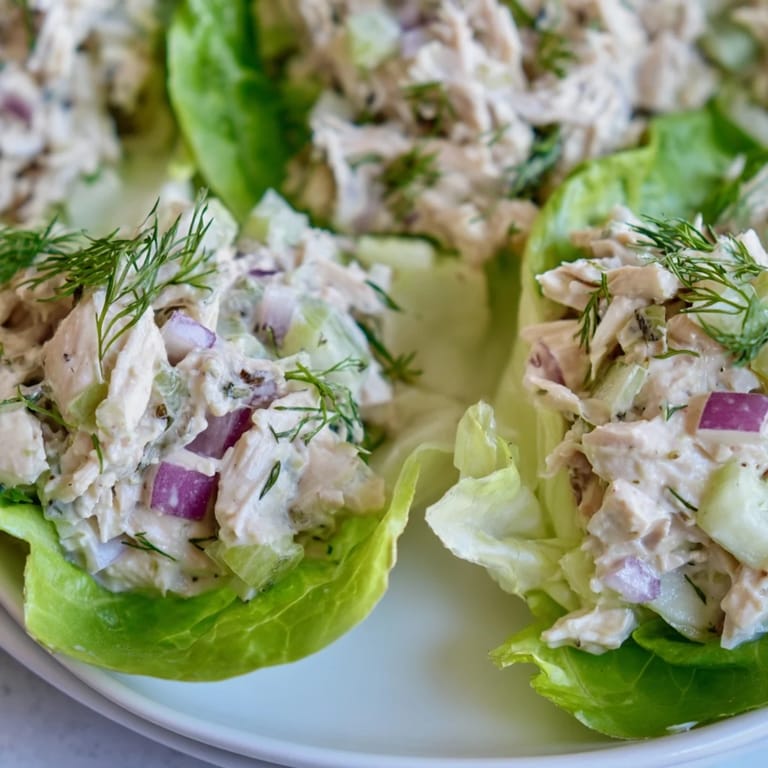 Ready-to-eat Dill Pickle Chicken Salad Lettuce Cups garnished with fresh dill, a quick low carb meal perfect for lunch or dinner.